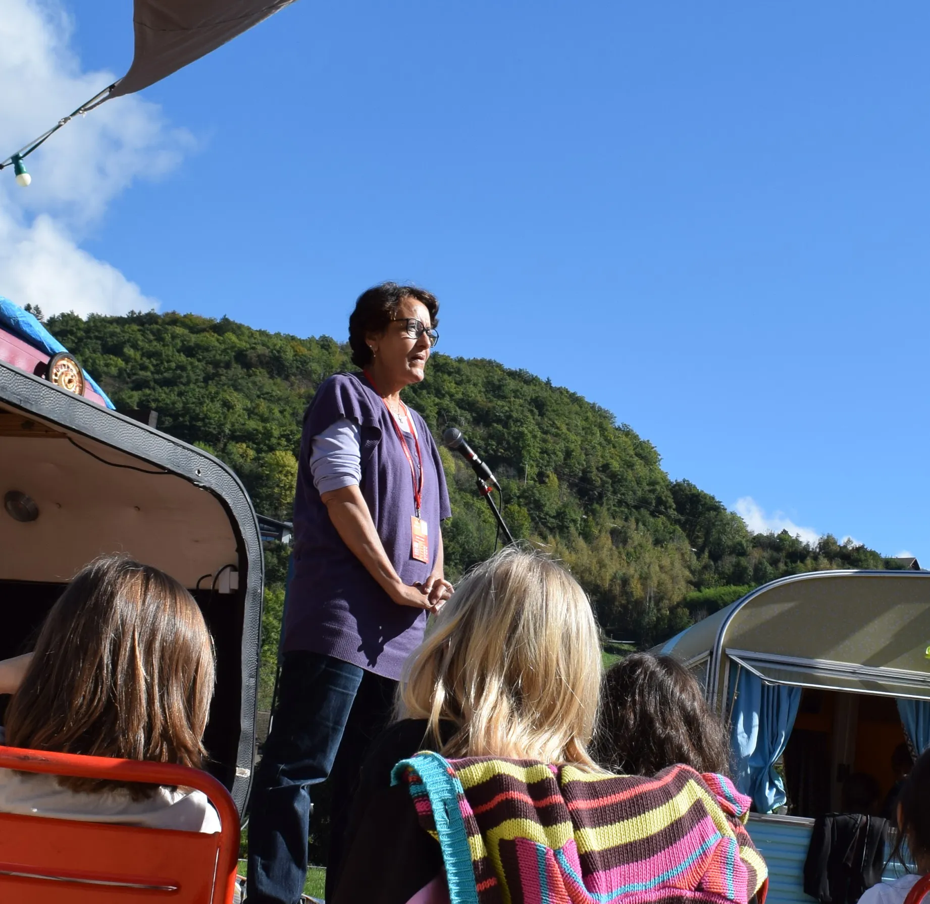 Zohra telling stories to a children's audience outdoors